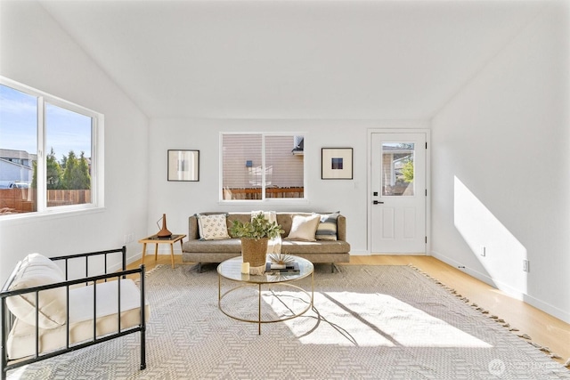 living area with baseboards and wood finished floors