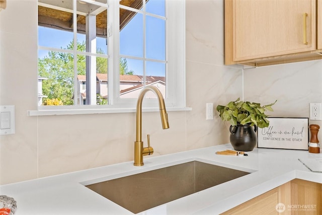 details with a sink, light brown cabinetry, and light countertops
