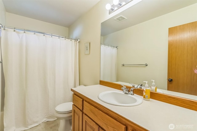 bathroom with visible vents, toilet, and vanity