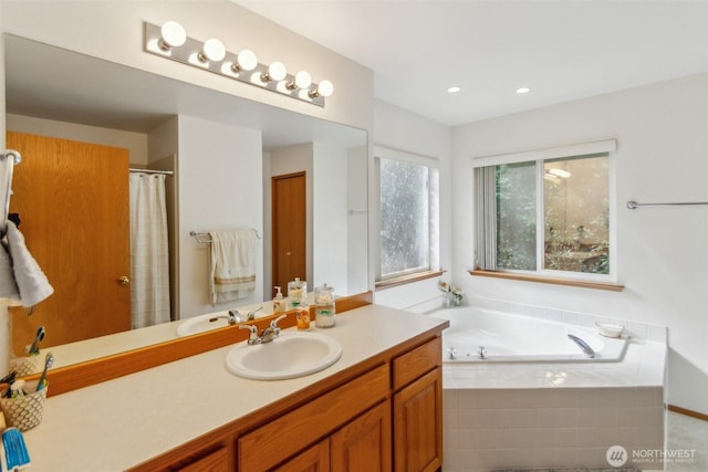 full bathroom featuring a garden tub, curtained shower, and vanity