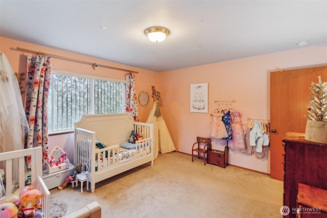 bedroom featuring carpet floors and a nursery area