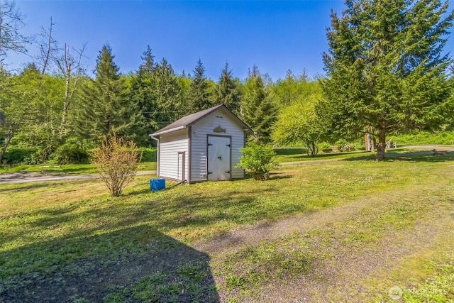 view of shed with a view of trees
