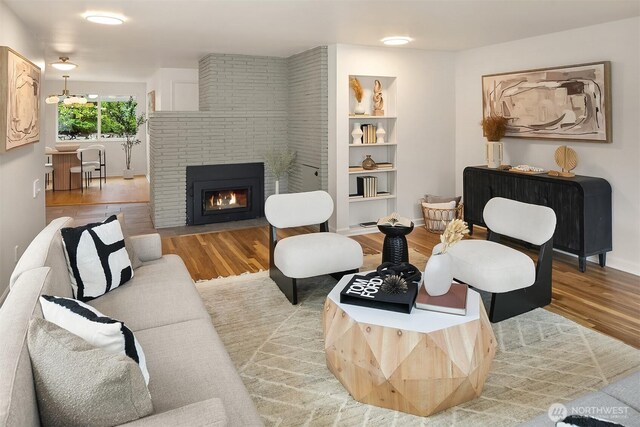 living room featuring wood finished floors and a fireplace