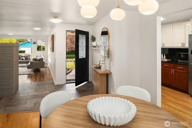 dining area featuring light wood-style floors