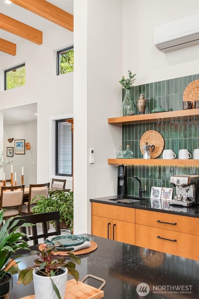 bar with beam ceiling, a sink, a wall mounted air conditioner, wet bar, and decorative backsplash