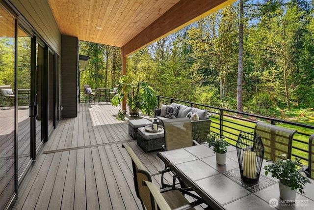 wooden deck with an outdoor living space and outdoor dining area