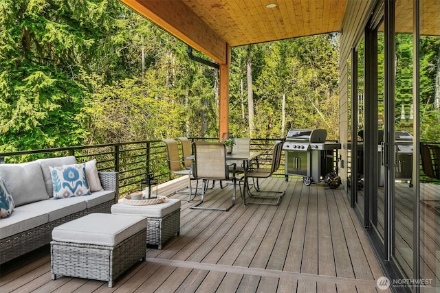 wooden terrace featuring an outdoor living space, outdoor dining area, and area for grilling