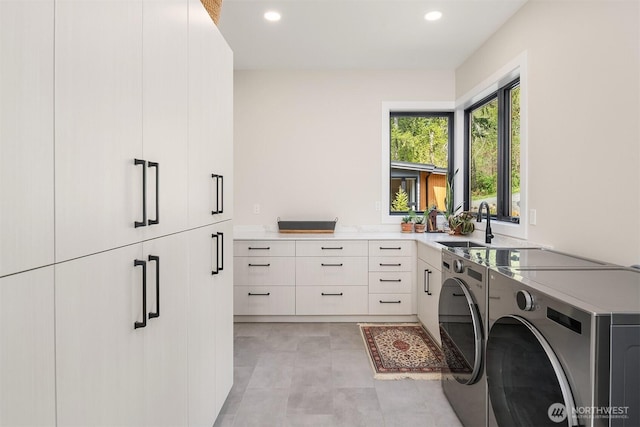laundry area with recessed lighting, a sink, cabinet space, and washing machine and clothes dryer