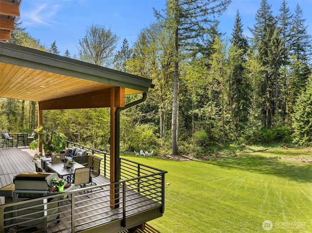 view of yard featuring a wooden deck and outdoor dining area