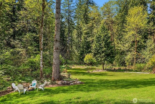 view of yard with a forest view
