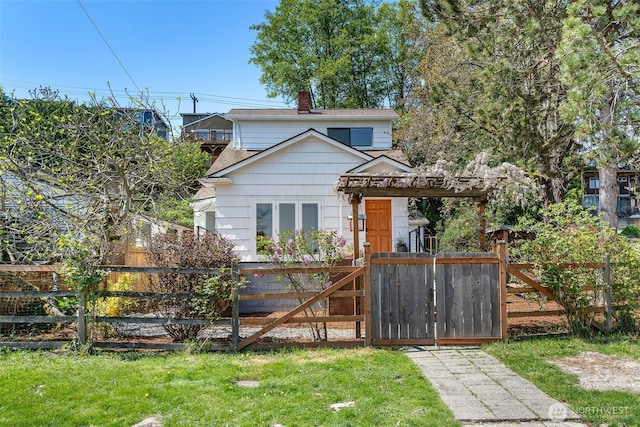 view of front of home with fence, a gate, a chimney, and roof with shingles