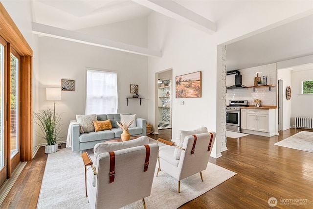 living area featuring vaulted ceiling, dark wood-style floors, and radiator