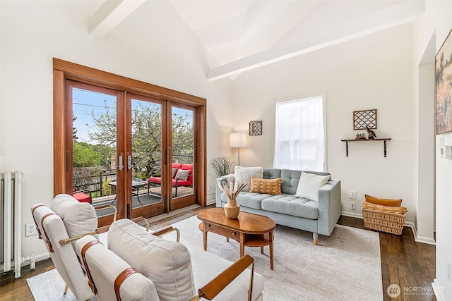 living room with french doors, radiator heating unit, baseboards, wood finished floors, and vaulted ceiling