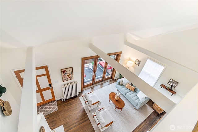 living area featuring wood finished floors and radiator heating unit