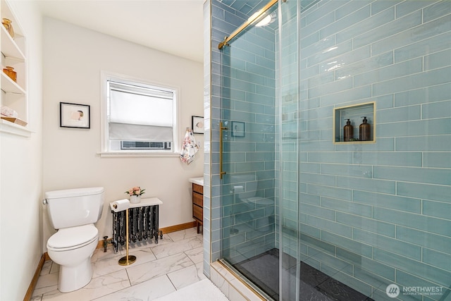 bathroom with vanity, toilet, marble finish floor, baseboards, and a shower stall