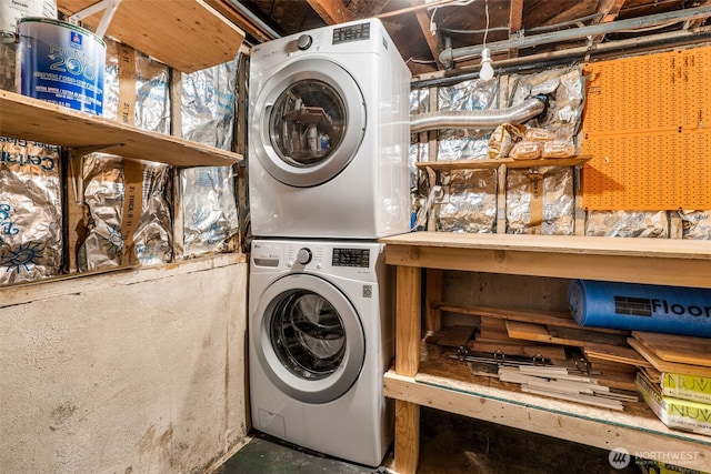 clothes washing area with stacked washer and dryer