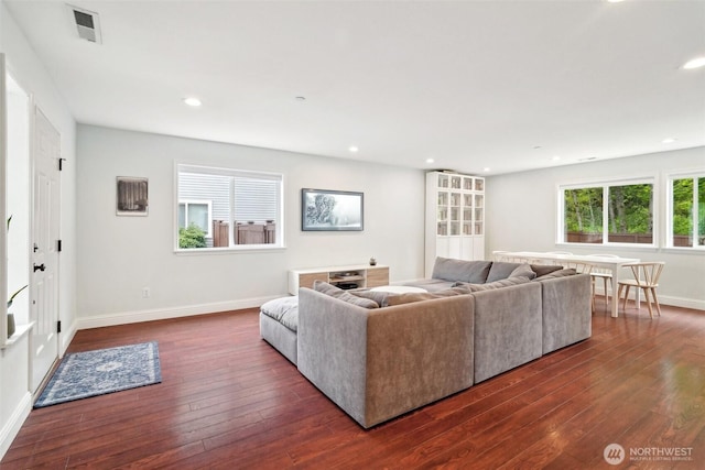 living area with visible vents, recessed lighting, dark wood finished floors, and baseboards