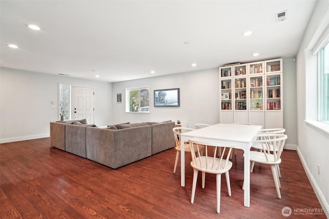 living area featuring dark wood-style flooring, recessed lighting, and a wealth of natural light
