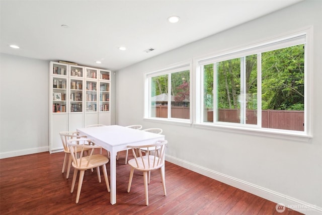dining space featuring baseboards, recessed lighting, wood finished floors, and visible vents