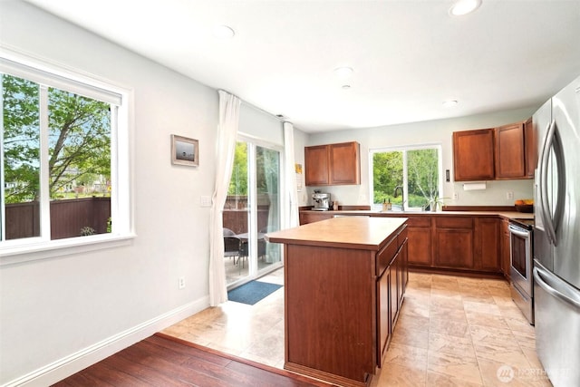 kitchen with plenty of natural light, a center island, and stainless steel appliances