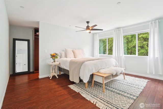 bedroom with baseboards, ceiling fan, and hardwood / wood-style floors