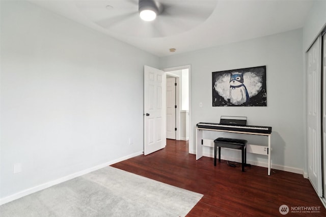 sitting room featuring baseboards, ceiling fan, and wood finished floors