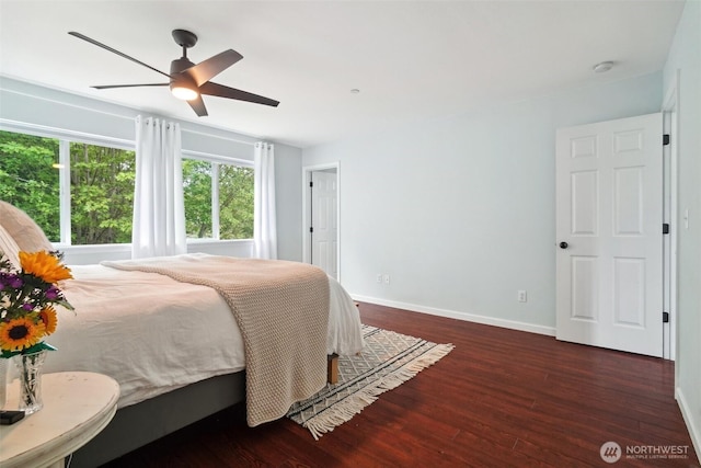bedroom featuring baseboards, ceiling fan, and wood finished floors