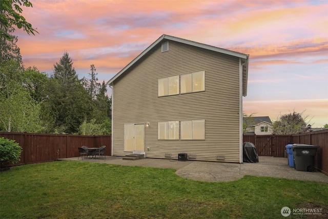 rear view of property featuring a yard, a patio, a fenced backyard, and entry steps