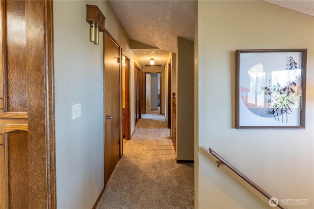 hall with light colored carpet
