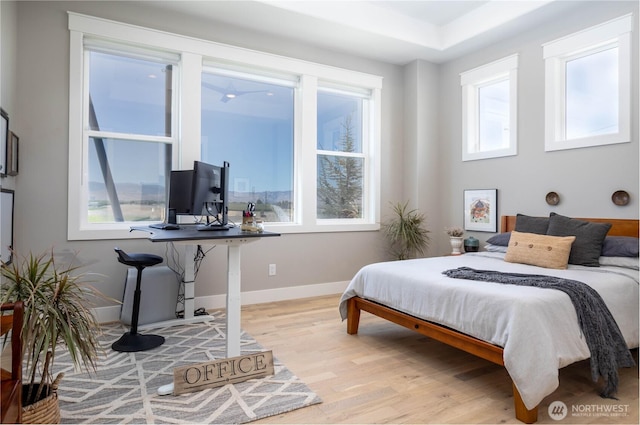 bedroom with baseboards and light wood-type flooring