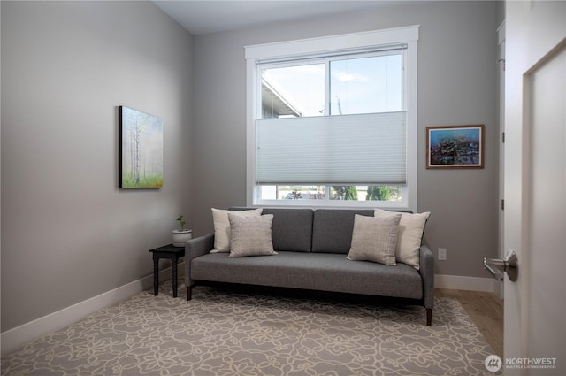 living area with baseboards and light wood-type flooring