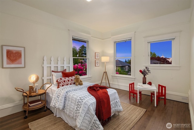 bedroom featuring wood finished floors and baseboards