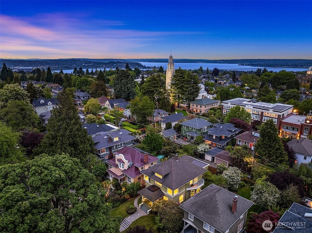 aerial perspective of suburban area featuring a nearby body of water