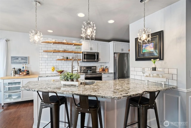 kitchen featuring backsplash, stainless steel appliances, and a notable chandelier