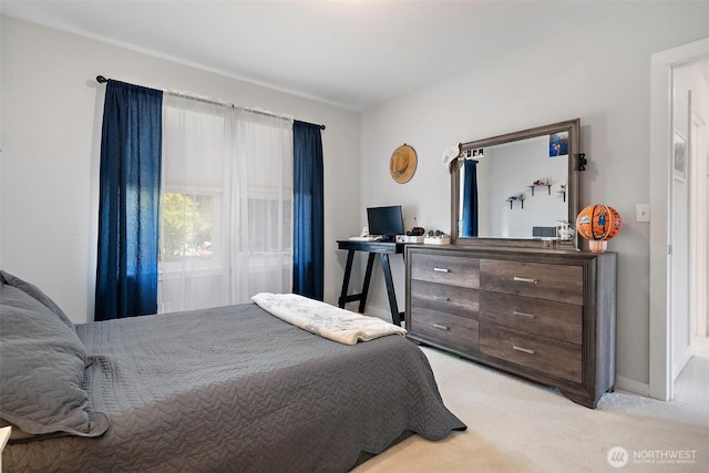 bedroom featuring baseboards and light colored carpet