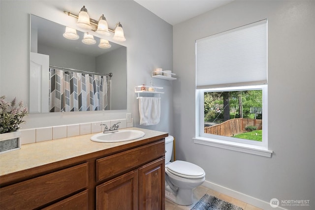 full bathroom featuring vanity, toilet, tile patterned floors, a shower with shower curtain, and baseboards
