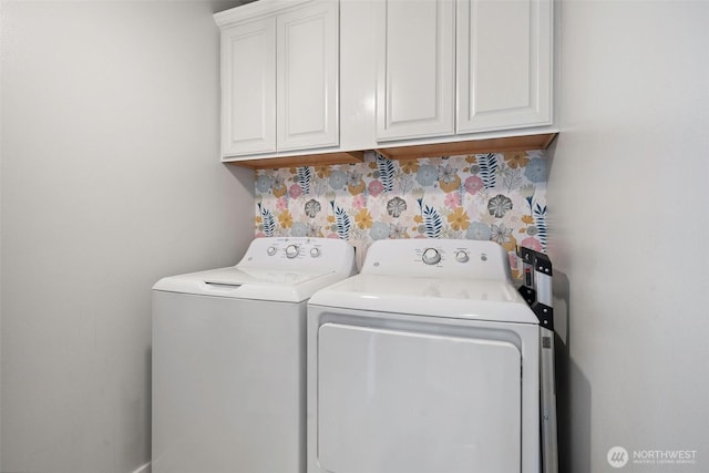 laundry area featuring separate washer and dryer and cabinet space