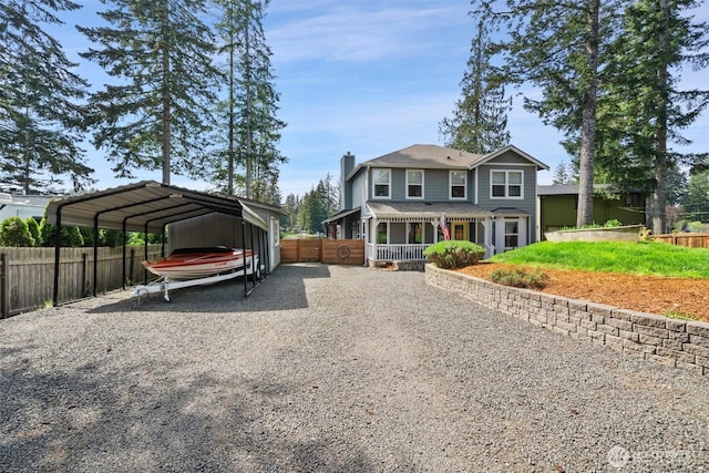exterior space featuring fence, driveway, a chimney, and a carport
