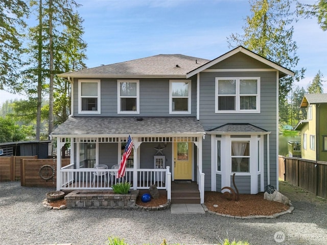 view of front of house featuring a porch, fence private yard, and roof with shingles