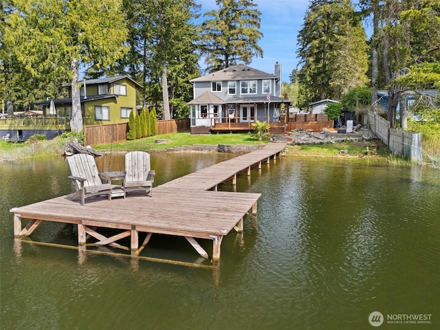 view of dock with a yard, fence private yard, and a deck with water view
