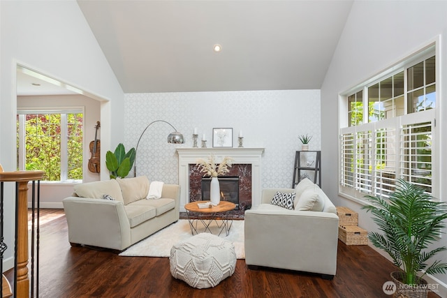 16653 SE 69th Way, Bellevue, WA 98006 - living room featuring lofted ceiling, wood finished floors, a fireplace, wallpapered walls, and baseboards