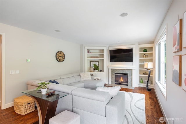 16653 SE 69th Way, Bellevue, WA 98006 - living area featuring dark wood-style floors, a fireplace with flush hearth, baseboards, and built in features
