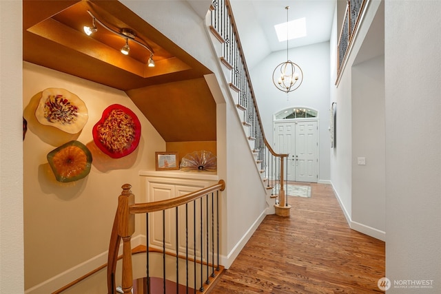 16653 SE 69th Way, Bellevue, WA 98006 - hall with wood finished floors, vaulted ceiling, baseboards, a chandelier, and stairs