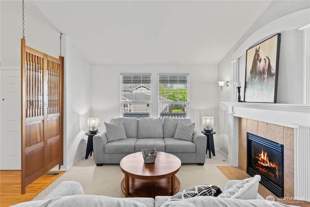 710 122nd Avenue Ct E, Edgewood, WA 98372 - living area with baseboards, lofted ceiling, and a tile fireplace