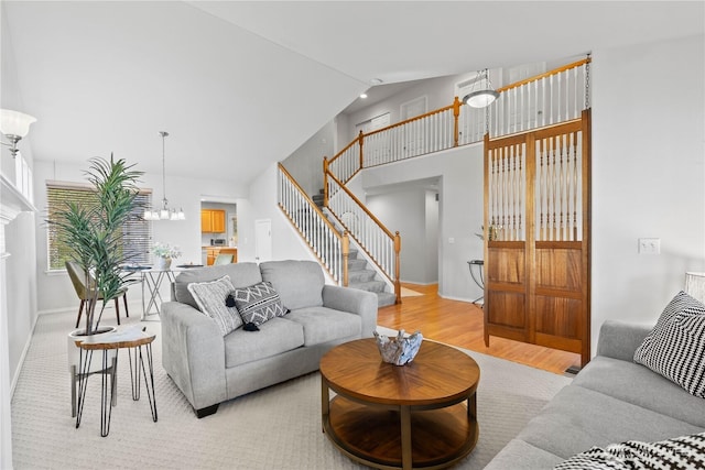 710 122nd Avenue Ct E, Edgewood, WA 98372 - living room featuring light wood-type flooring, baseboards, a chandelier, and stairway