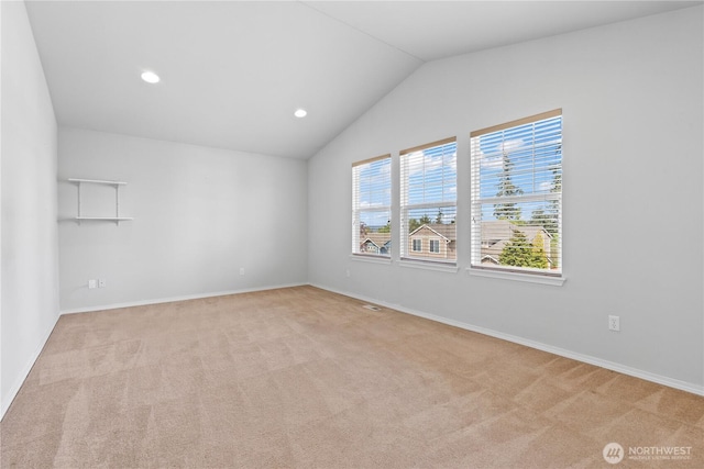 710 122nd Avenue Ct E, Edgewood, WA 98372 - spare room with baseboards, light carpet, and vaulted ceiling