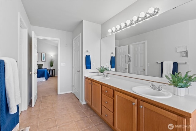 710 122nd Avenue Ct E, Edgewood, WA 98372 - bathroom with a sink, baseboards, tile patterned flooring, and double vanity