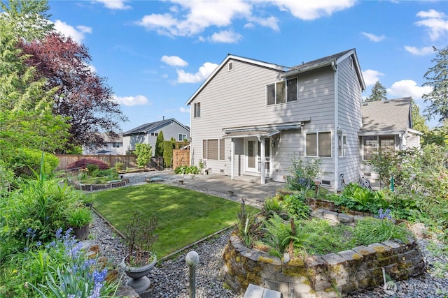710 122nd Avenue Ct E, Edgewood, WA 98372 - back of house featuring a lawn, a patio, fence private yard, and a vegetable garden