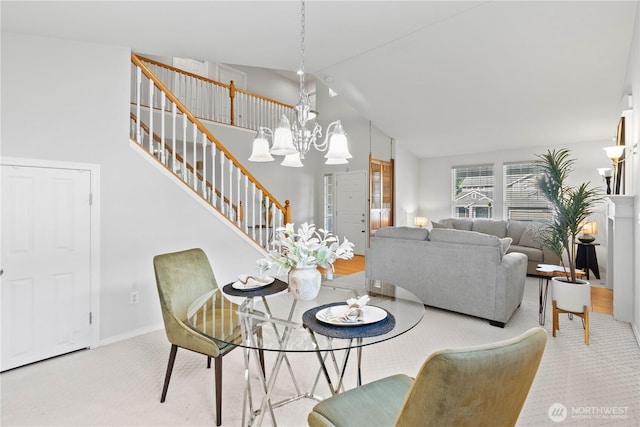 710 122nd Avenue Ct E, Edgewood, WA 98372 - dining space featuring carpet, high vaulted ceiling, a chandelier, and stairway