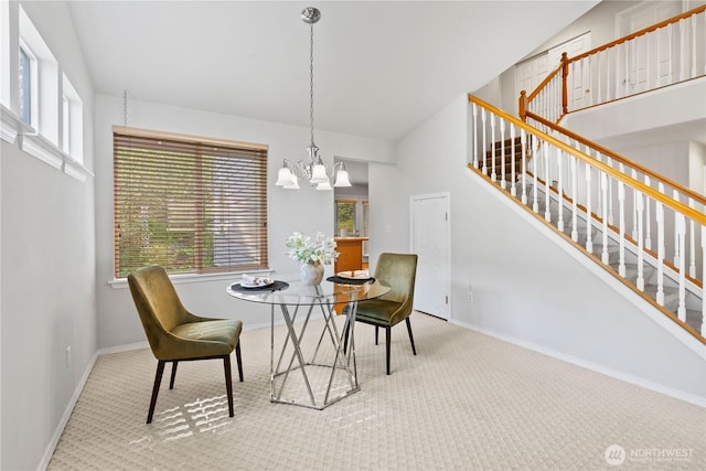 710 122nd Avenue Ct E, Edgewood, WA 98372 - carpeted dining area featuring baseboards, a chandelier, and stairway